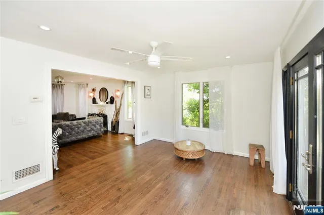 a bedroom with furniture and a large window