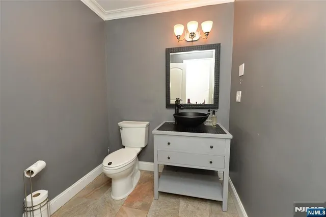 a white toilet sitting next to a bathroom sink