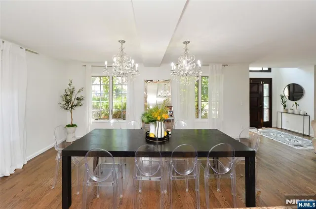 a kitchen with a chandelier dining table and chairs