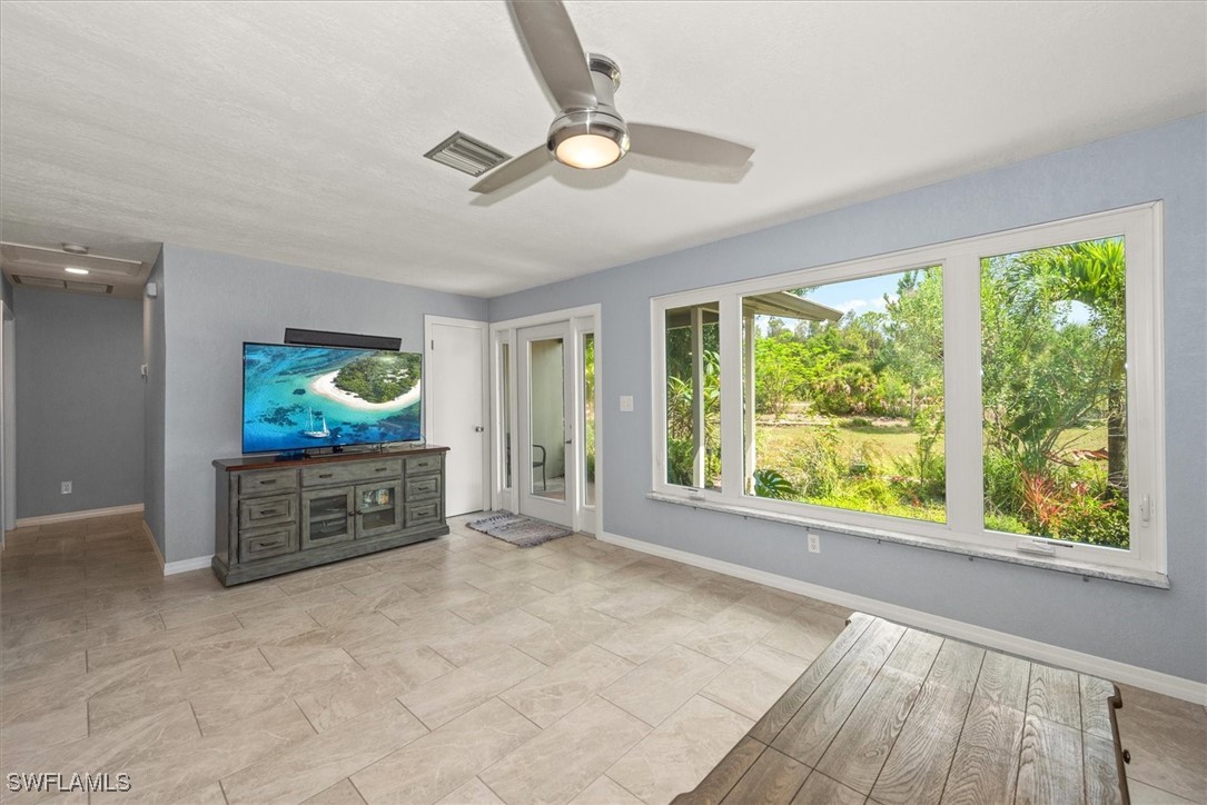 13951 Rod And Gun Club Road Fort Myers, FL 33913 - Photo 12 of 49 a view of an empty room with a window and kitchen view