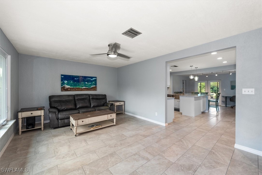 13951 Rod And Gun Club Road Fort Myers, FL 33913 - Photo 16 of 49 a living room with furniture and a flat screen tv