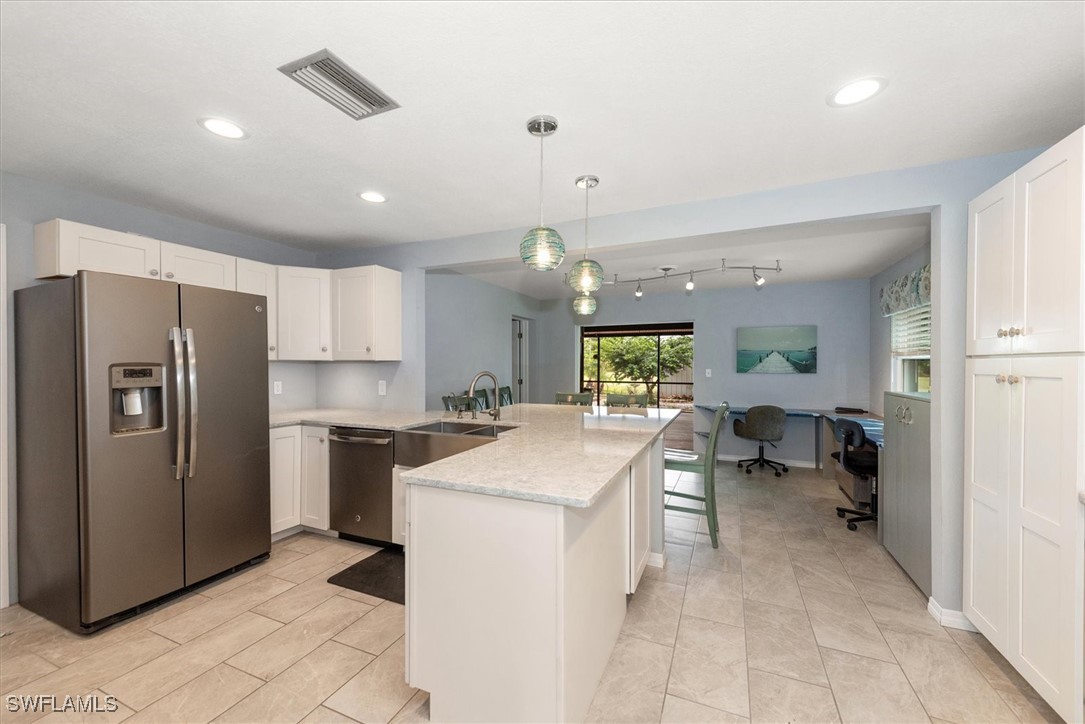 13951 Rod And Gun Club Road Fort Myers, FL 33913 - Photo 18 of 49 a kitchen with a sink stainless steel appliances and cabinets