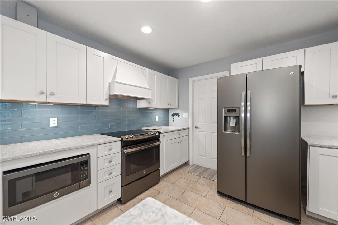 13951 Rod And Gun Club Road Fort Myers, FL 33913 - Photo 19 of 49 a kitchen with stainless steel appliances granite countertop a refrigerator stove and sink