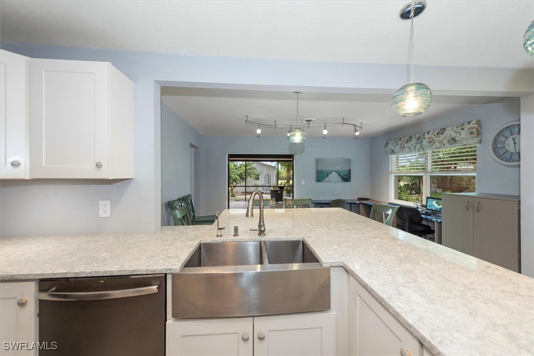 13951 Rod And Gun Club Road Fort Myers, FL 33913 - Photo 20 of 49 a kitchen with kitchen island granite countertop a sink a counter top space and stainless steel appliances