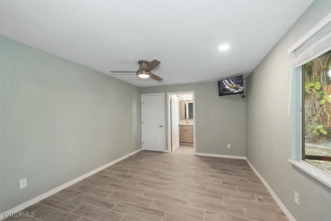 13951 Rod And Gun Club Road Fort Myers, FL 33913 - Photo 24 of 49 wooden floor in an empty room with a window