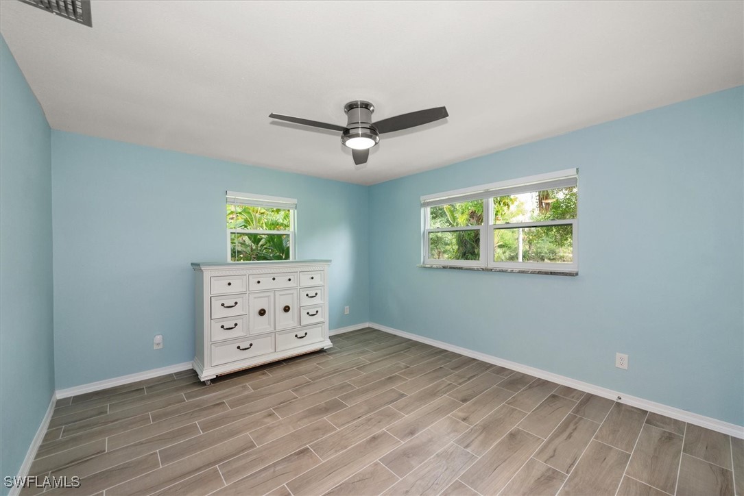 13951 Rod And Gun Club Road Fort Myers, FL 33913 - Photo 26 of 49 an empty room with windows and cabinet