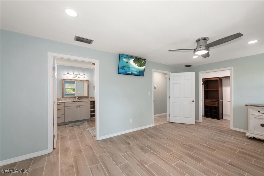 13951 Rod And Gun Club Road Fort Myers, FL 33913 - Photo 28 of 49 wooden floor in an empty room and a cabinet