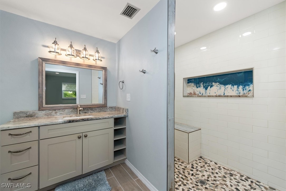 13951 Rod And Gun Club Road Fort Myers, FL 33913 - Photo 30 of 49 a bathroom with a sink and a mirror