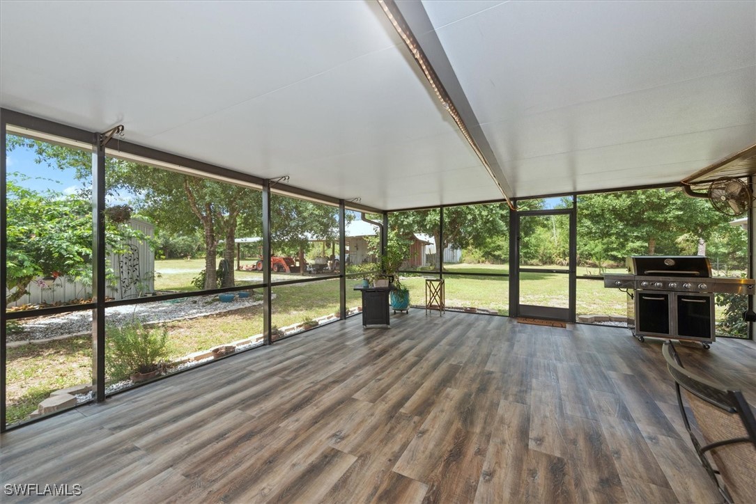 13951 Rod And Gun Club Road Fort Myers, FL 33913 - Photo 37 of 49 an empty room with wooden floor and large windows
