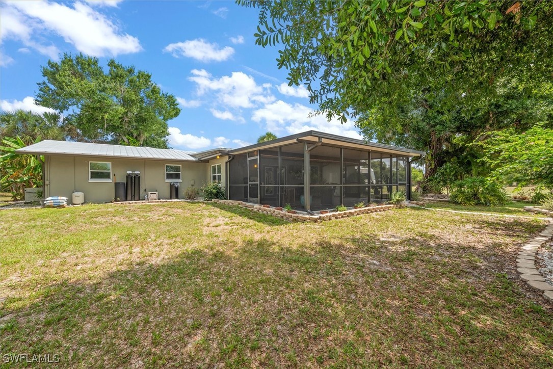 13951 Rod And Gun Club Road Fort Myers, FL 33913 - Photo 39 of 49 a house view with a garden space