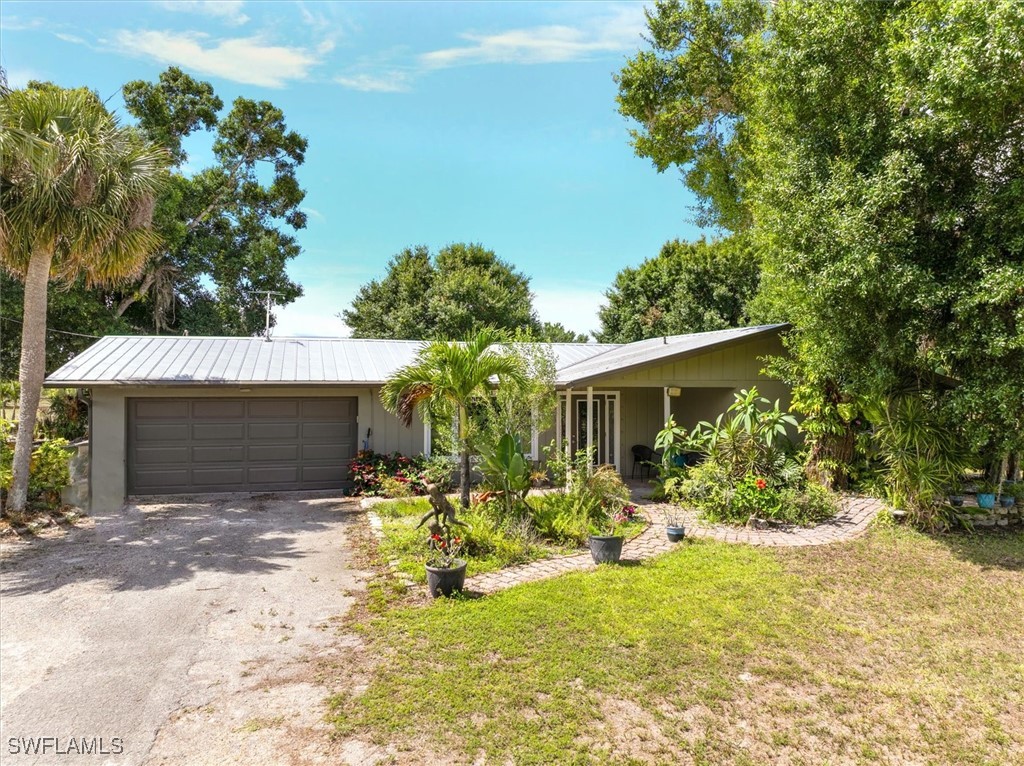 13951 Rod And Gun Club Road Fort Myers, FL 33913 - Photo 4 of 49 a view of a house with yard and sitting area