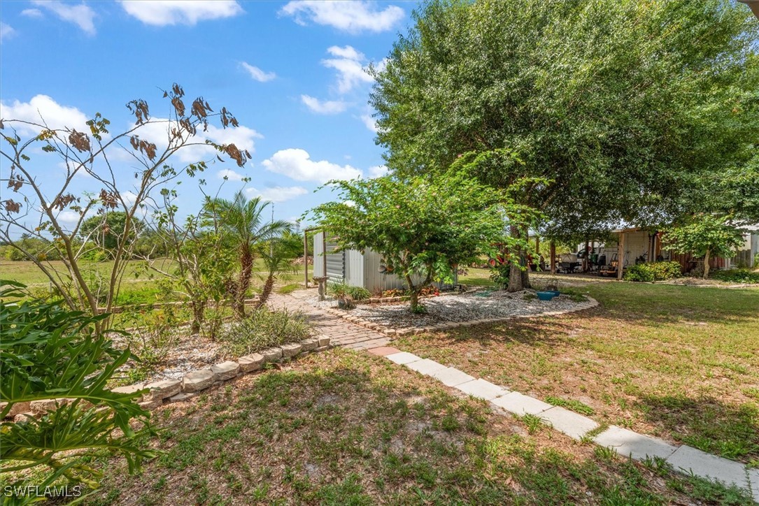 13951 Rod And Gun Club Road Fort Myers, FL 33913 - Photo 41 of 49 a view of a house with a yard