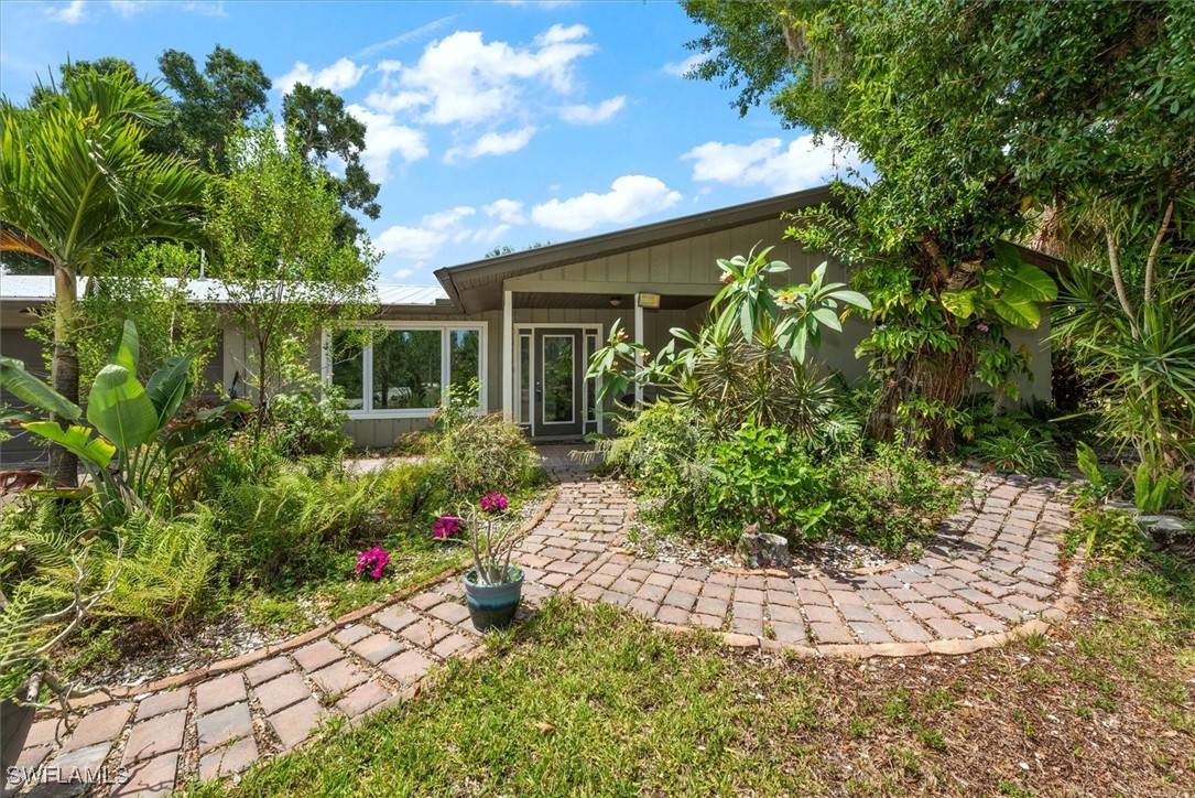 13951 Rod And Gun Club Road Fort Myers, FL 33913 - Photo 6 of 49 a front view of a house with a yard