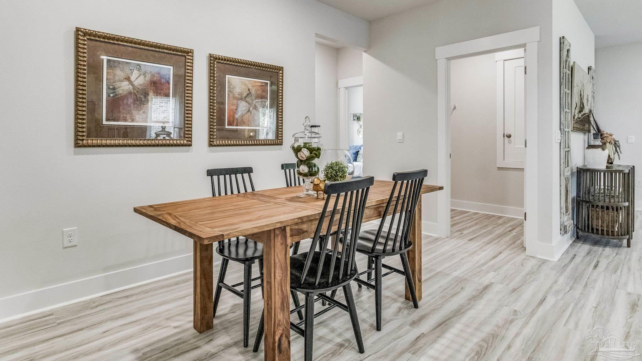 5856 Dove Nest Road Gulf Breeze, FL 32563 - Photo 12 of 33 a dining room with furniture and wooden floor
