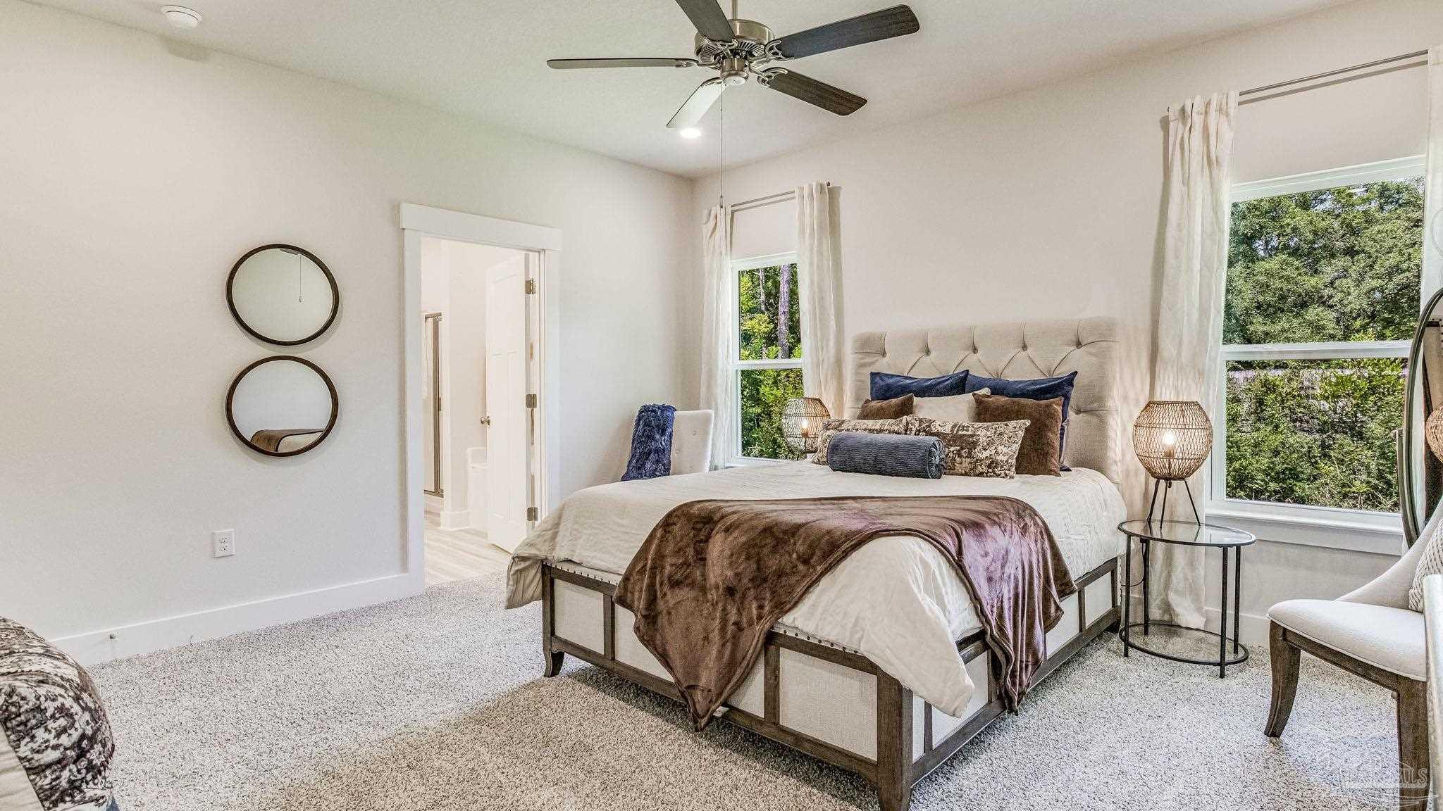 5856 Dove Nest Road Gulf Breeze, FL 32563 - Photo 15 of 33 a bedroom with a bed a window and a chandelier