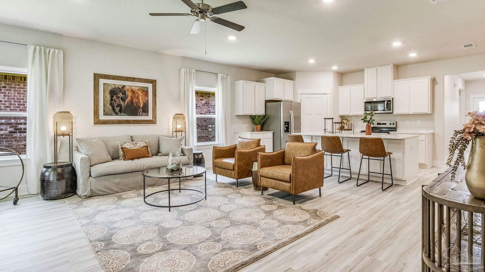 5856 Dove Nest Road Gulf Breeze, FL 32563 - Photo 4 of 33 a living room with furniture and a wooden floor
