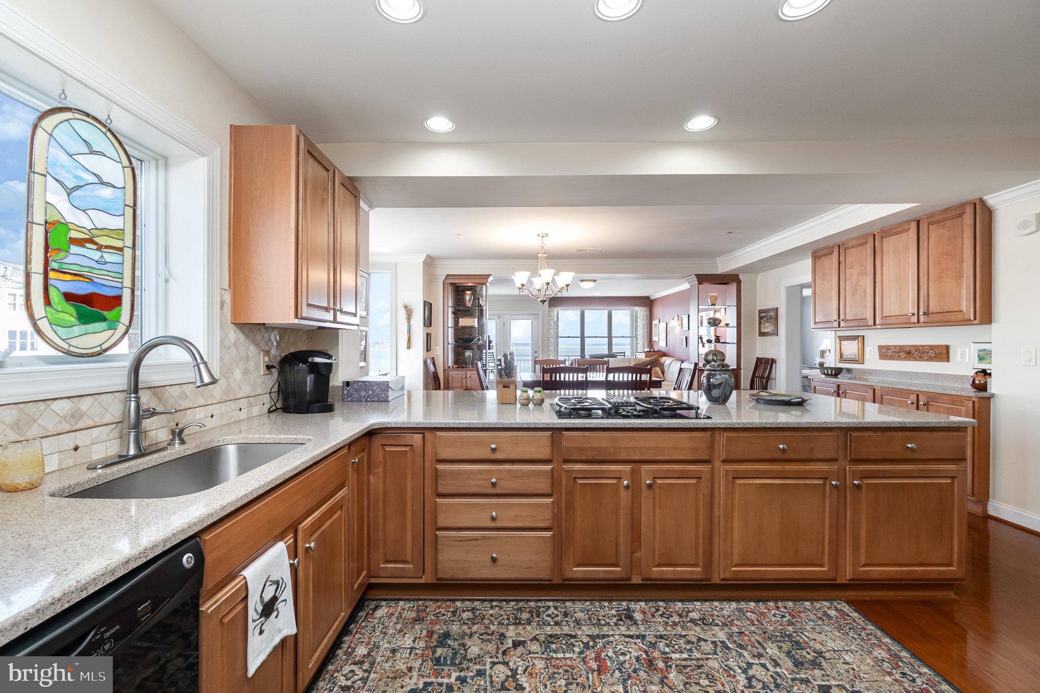 605 Concord Street, Unit 3E Havre de Grace, MD 21078 - Photo 15 of 59 a kitchen with stainless steel appliances kitchen island granite countertop a sink and cabinets