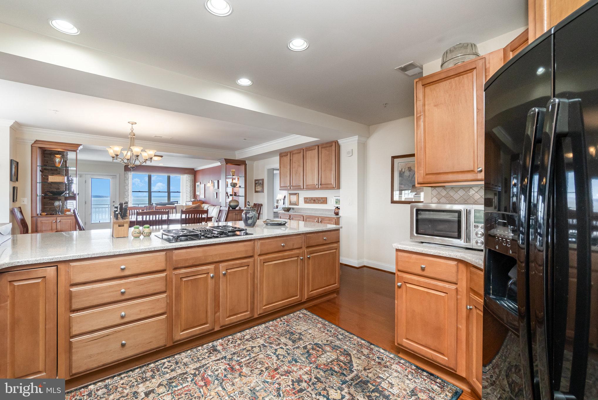 605 Concord Street, Unit 3E Havre de Grace, MD 21078 - Photo 16 of 59 a kitchen with stainless steel appliances kitchen island granite countertop a refrigerator and cabinets