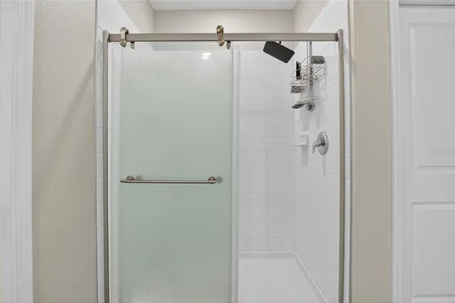 a view of walk in closet with clothes