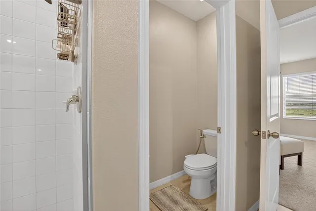 a bathroom with a granite countertop double vanity sink and a mirror