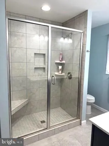 a bathroom with a glass shower door