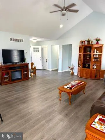 a living room with furniture flat screen tv and gym equipment