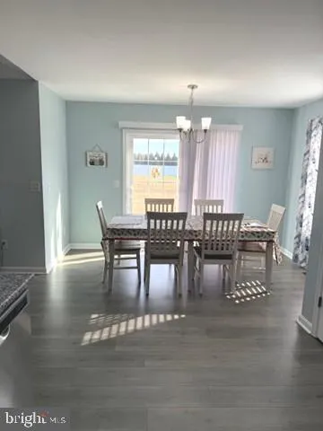 a dining room with furniture window and wooden floor