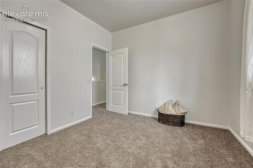 7285 Julynn Road Colorado Springs, CO 80919 - Photo 19 of 45 a view of an empty room and wooden floor
