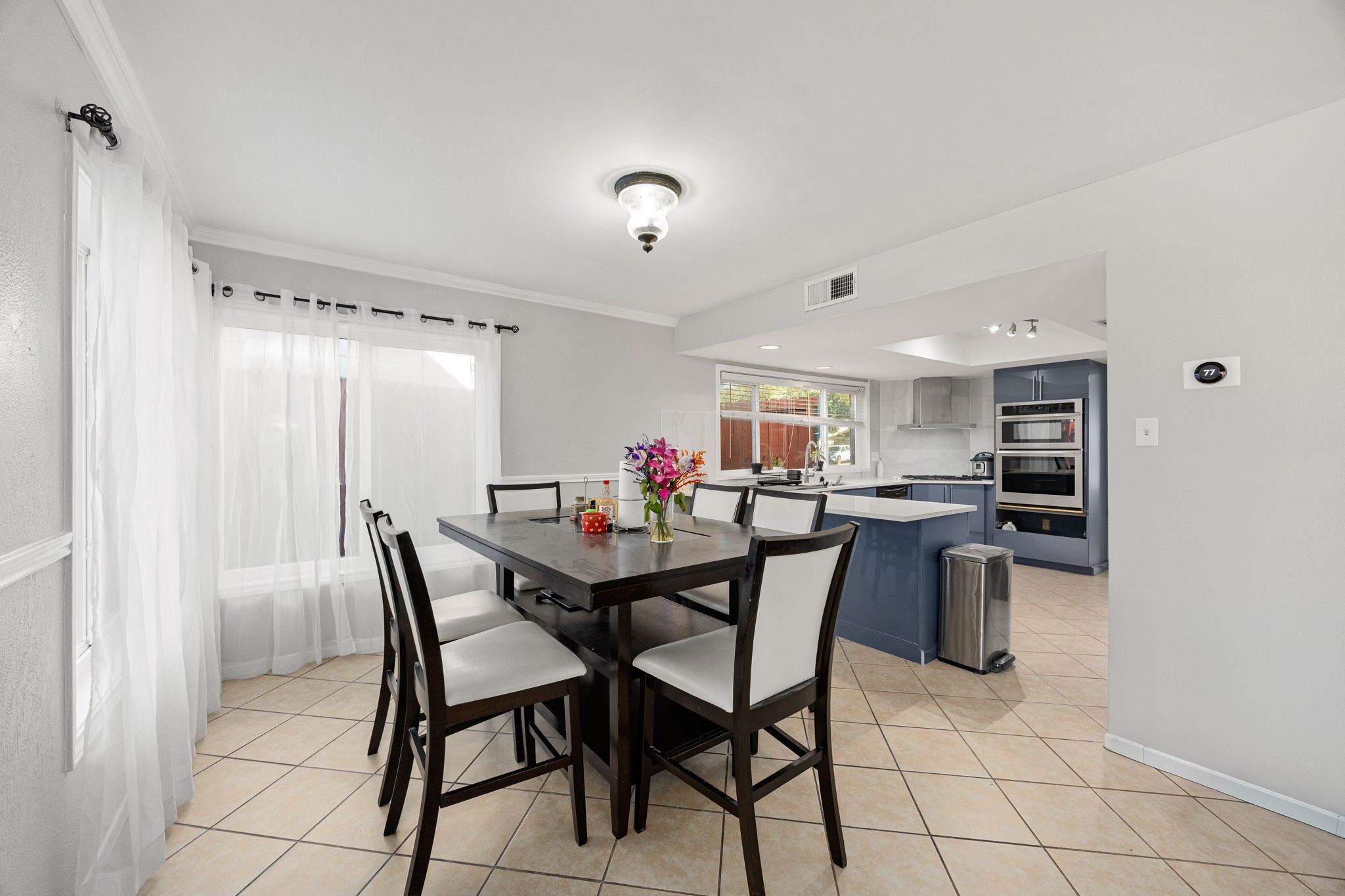9907 Gold Cup Way Houston, TX 77065 - Photo 12 of 39 a view of a dining room with furniture and a chandelier