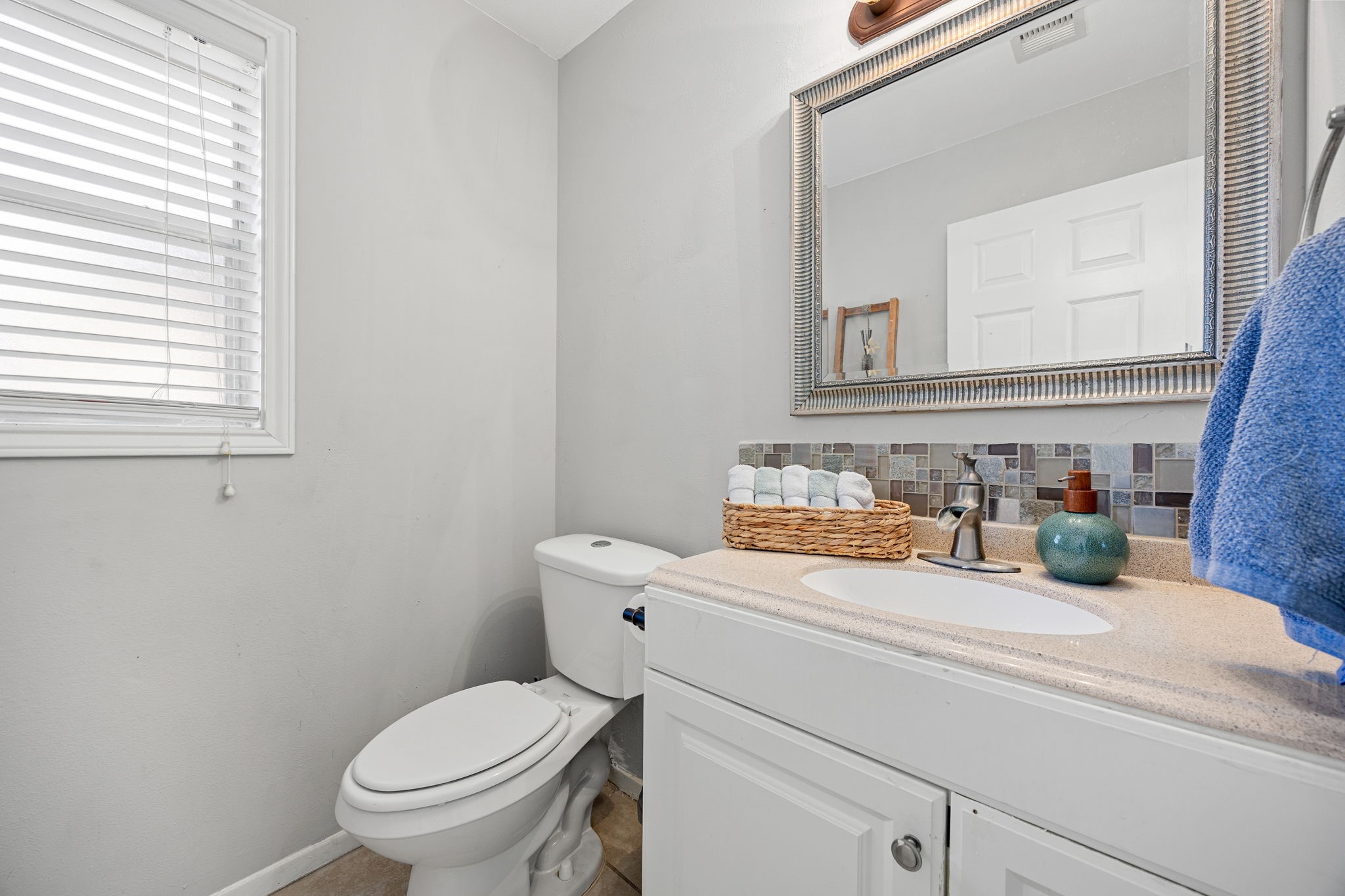 9907 Gold Cup Way Houston, TX 77065 - Photo 17 of 39 a bathroom with a toilet sink and mirror
