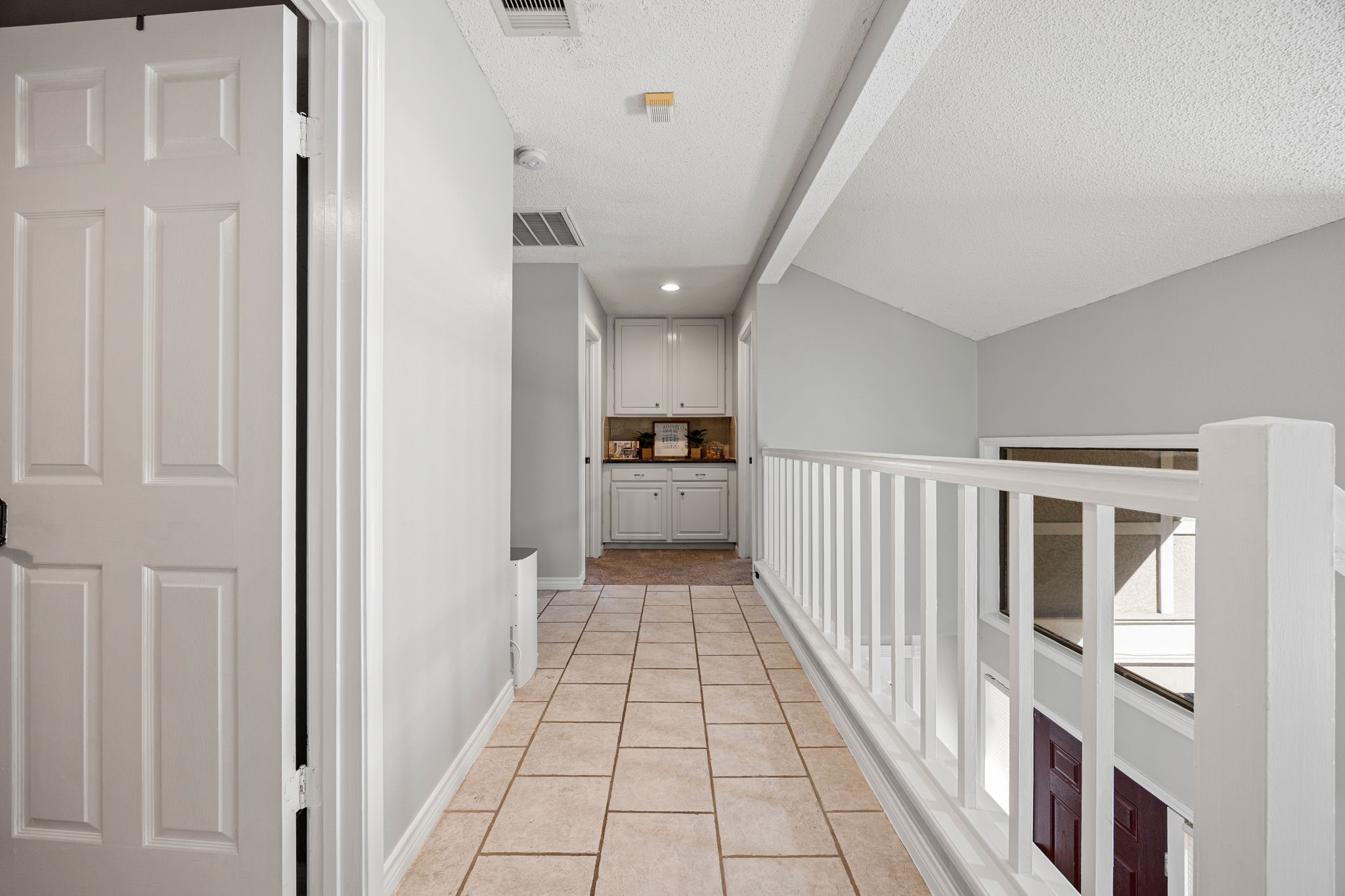 9907 Gold Cup Way Houston, TX 77065 - Photo 18 of 39 a view of a hallway with wooden floor and staircase