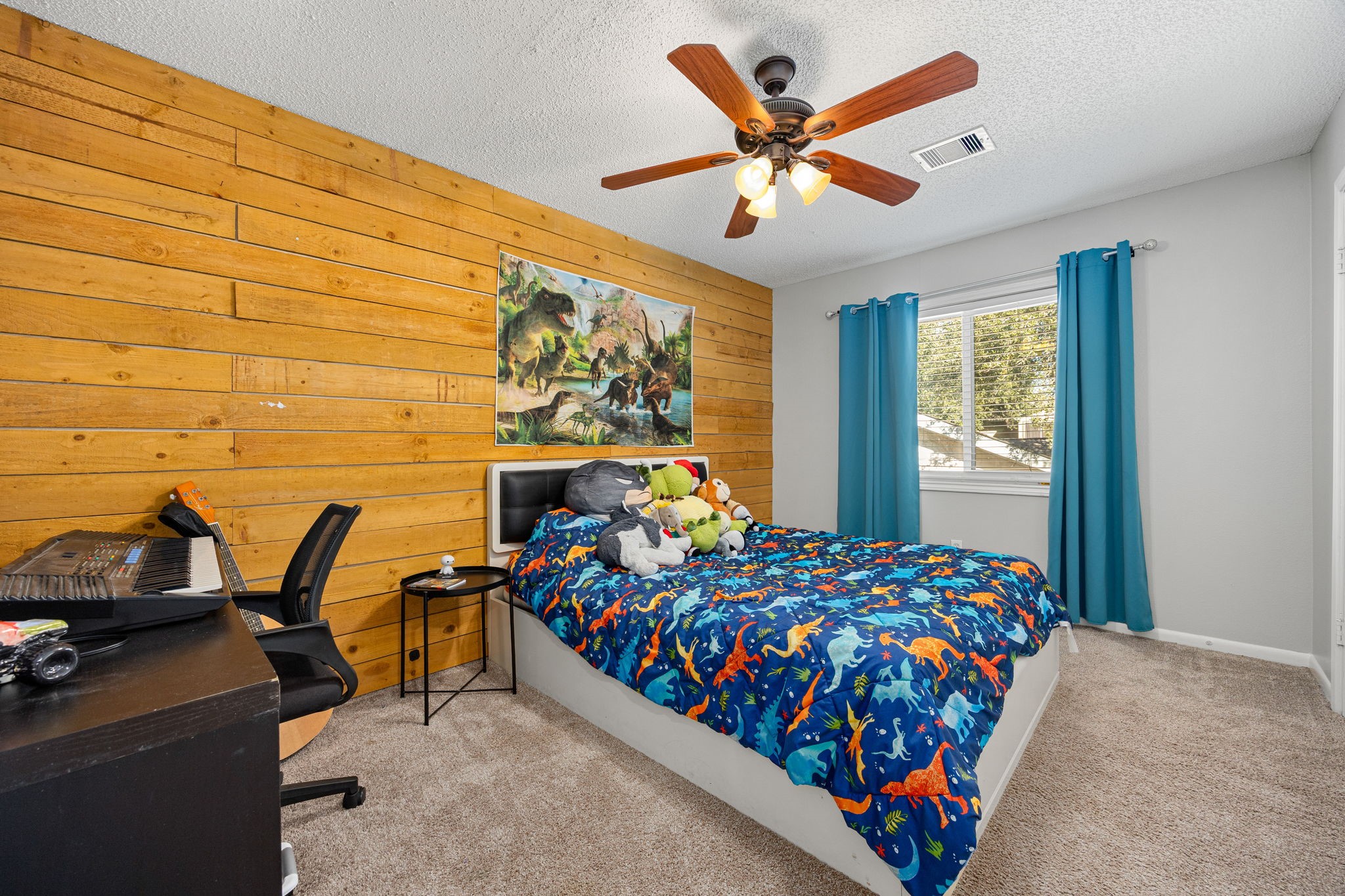 9907 Gold Cup Way Houston, TX 77065 - Photo 23 of 39 a bed sitting in a bedroom next to a window
