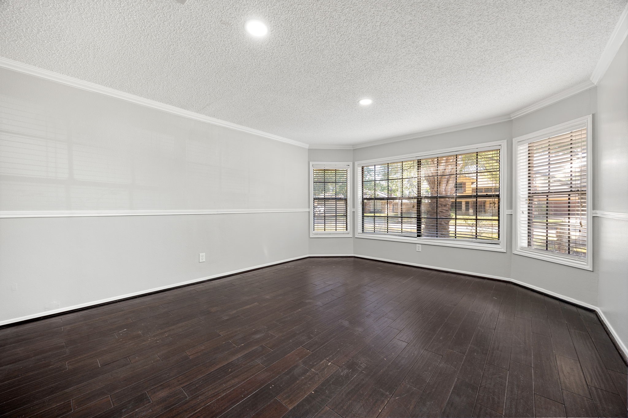 9907 Gold Cup Way Houston, TX 77065 - Photo 9 of 39 a view of an empty room with wooden floor and a window