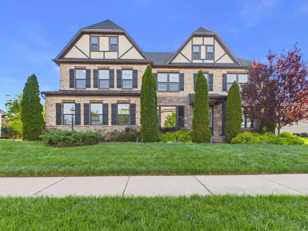a front view of a house with a yard