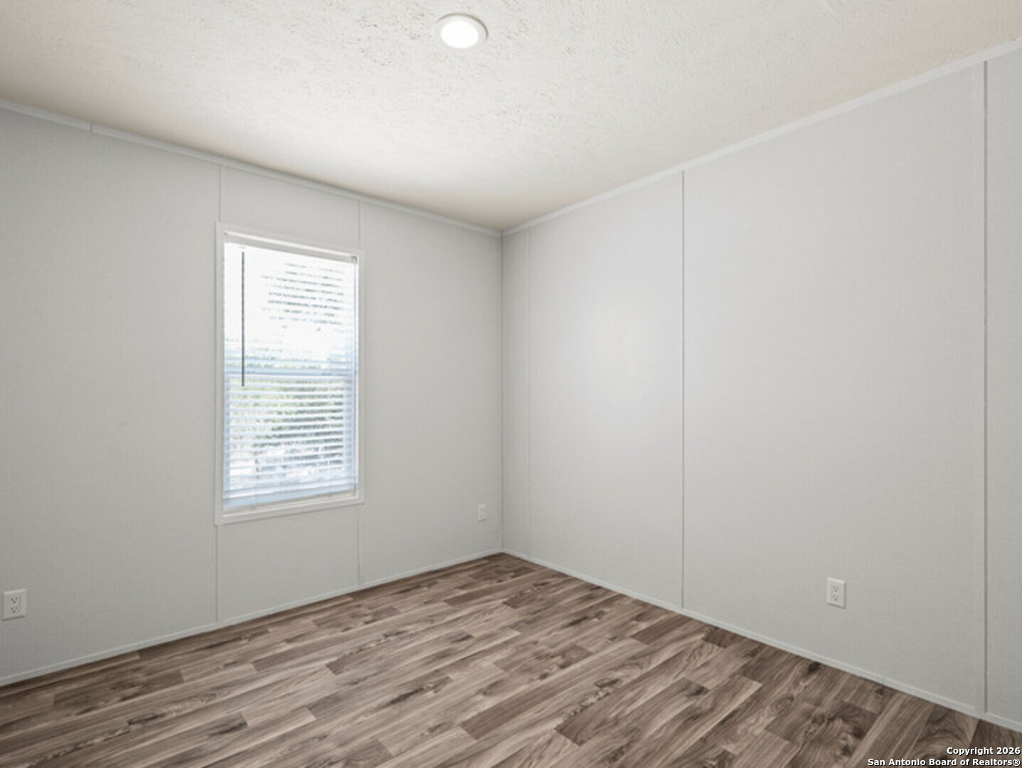 1144 Turkey Canyon Drive Spring Branch, TX 78070 - Photo 11 of 23 an empty room with wooden floor and windows