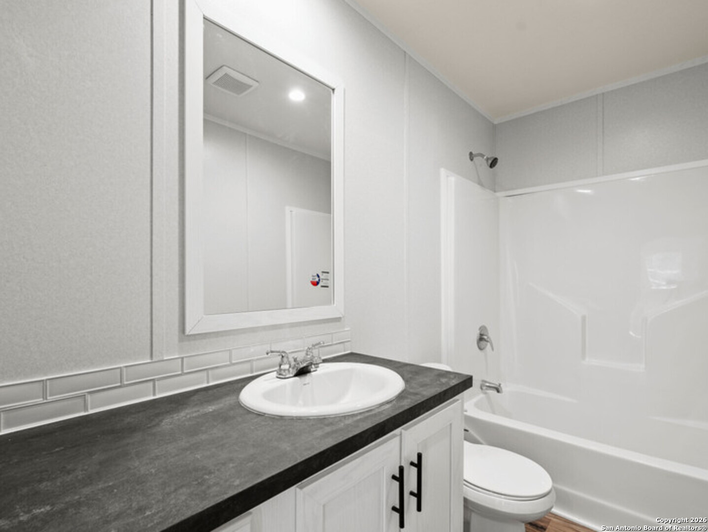 1144 Turkey Canyon Drive Spring Branch, TX 78070 - Photo 13 of 23 a bathroom with a granite countertop sink toilet and shower