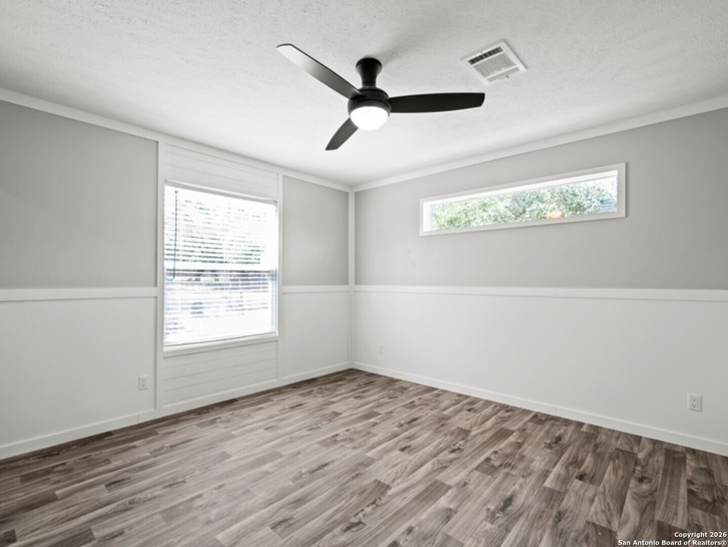 1144 Turkey Canyon Drive Spring Branch, TX 78070 - Photo 16 of 23 a view of empty room with wooden floor and fan