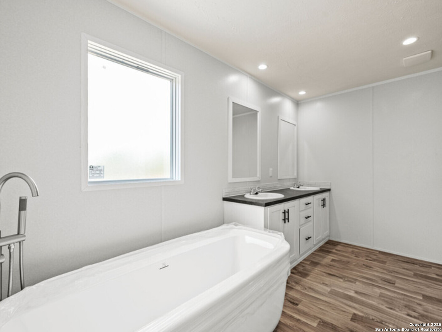 1144 Turkey Canyon Drive Spring Branch, TX 78070 - Photo 19 of 23 a bathroom with a tub sink and mirror