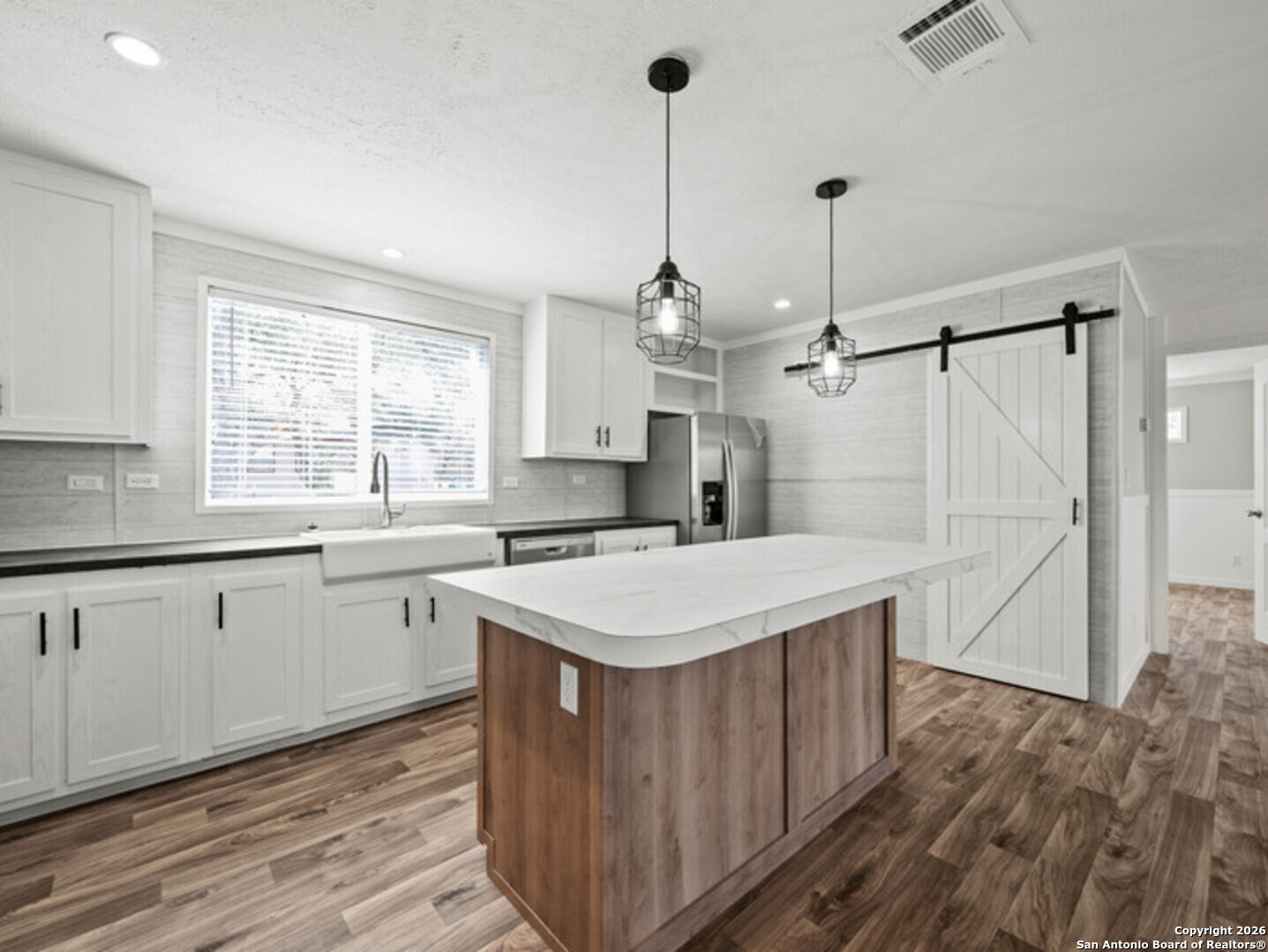 1144 Turkey Canyon Drive Spring Branch, TX 78070 - Photo 7 of 23 a kitchen with a sink a window stainless steel appliances and cabinets