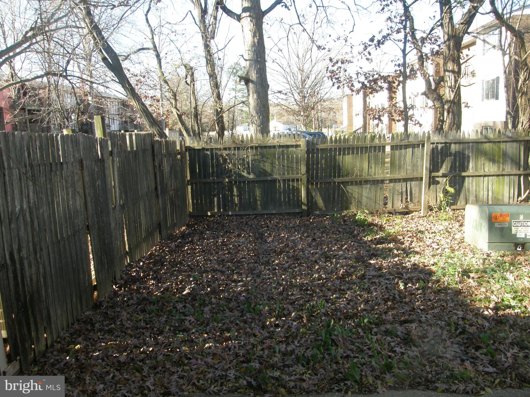 22087 Spring Valley Drive Lexington Park, MD 20653 - Photo 25 of 29 a backyard of a house with lots of green space and fountain