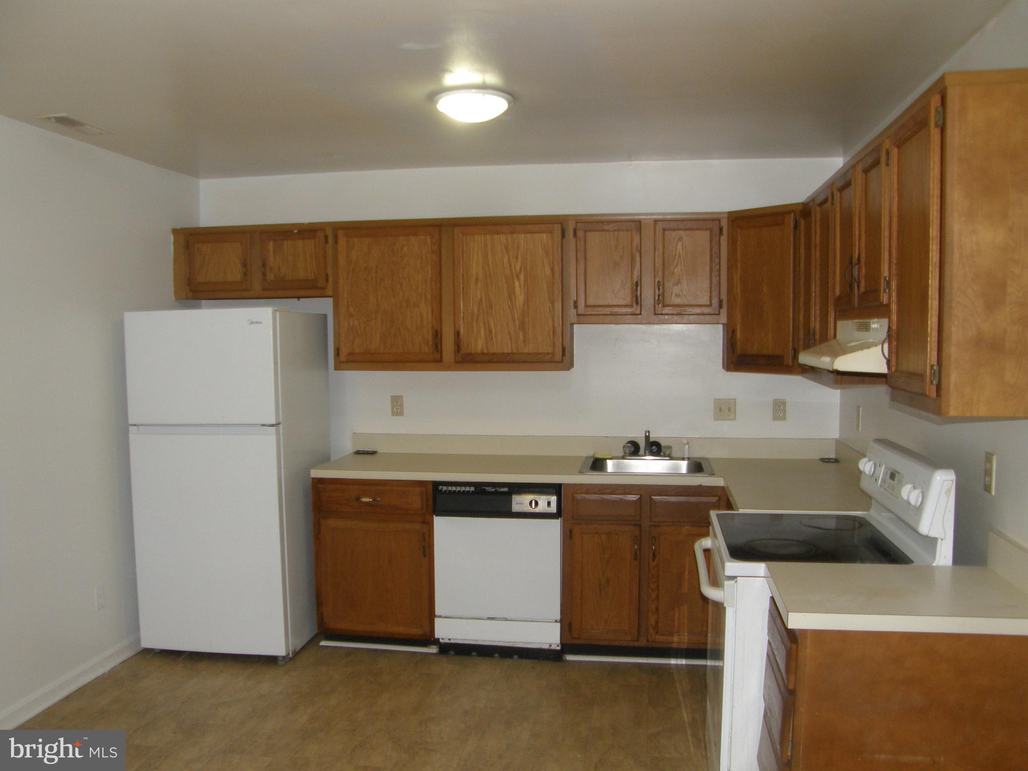 22087 Spring Valley Drive Lexington Park, MD 20653 - Photo 6 of 29 a kitchen with a sink a stove and a refrigerator