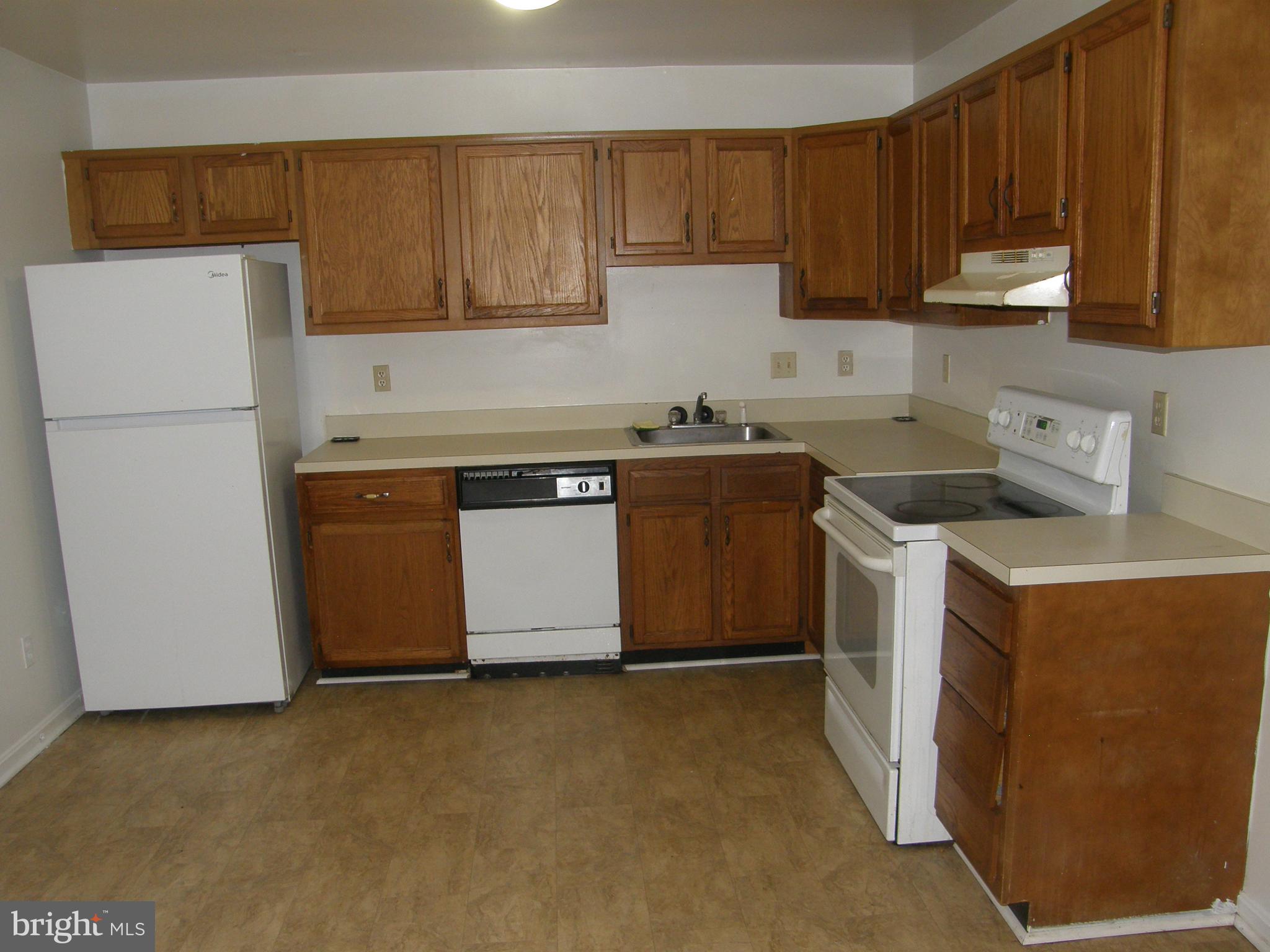 22087 Spring Valley Drive Lexington Park, MD 20653 - Photo 7 of 29 a kitchen with a sink a stove and a refrigerator