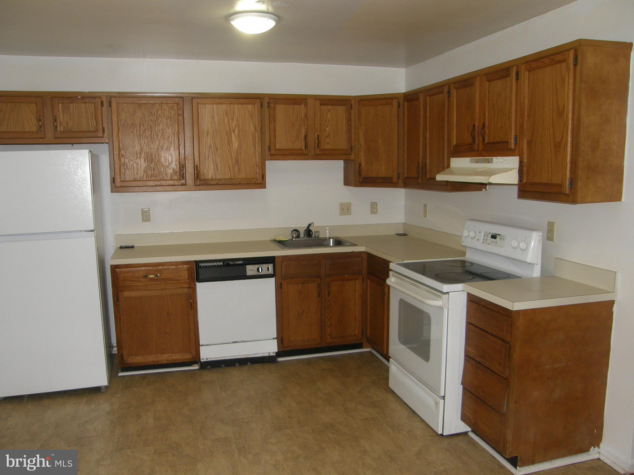 22087 Spring Valley Drive Lexington Park, MD 20653 - Photo 8 of 29 a kitchen with a stove top oven sink and cabinets