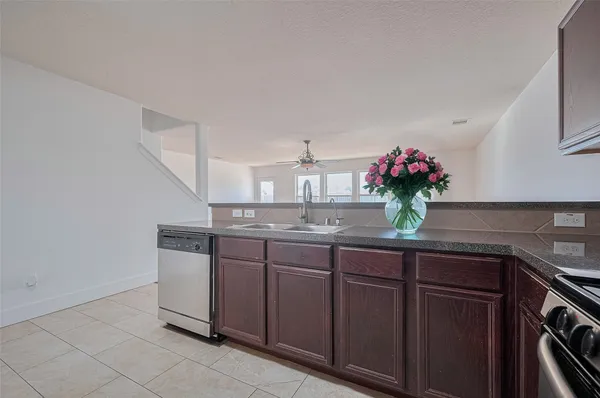 a kitchen with granite countertop a sink and cabinets