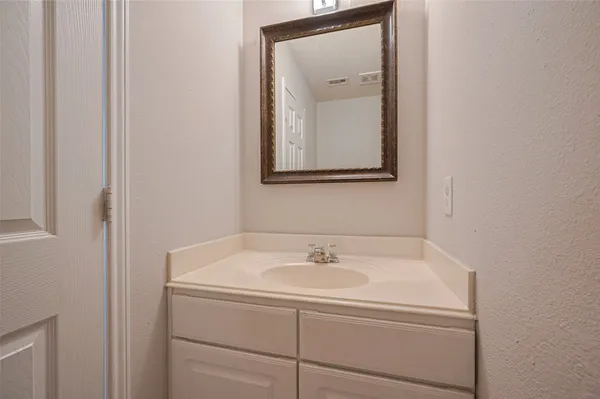 a bathroom with a sink and mirror