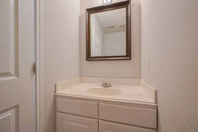 a bathroom with a sink and mirror