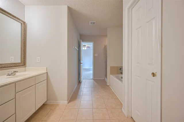 a bathroom with a double vanity sink and mirror