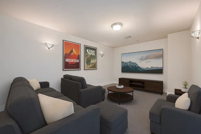 a living room with furniture and a painting on the wall