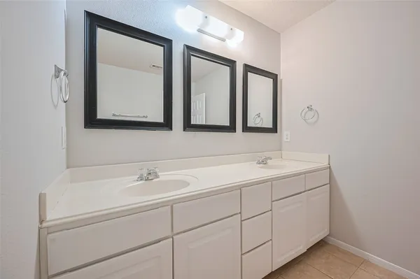 a bathroom with 2 sink and a mirror