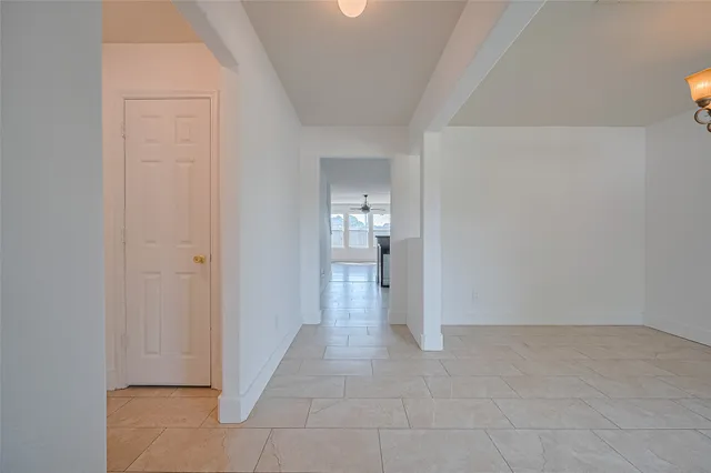 a view of a hallway with wooden shelves